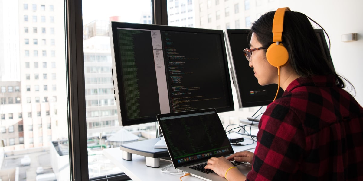 A full-stack designer sitting at a computer in an office