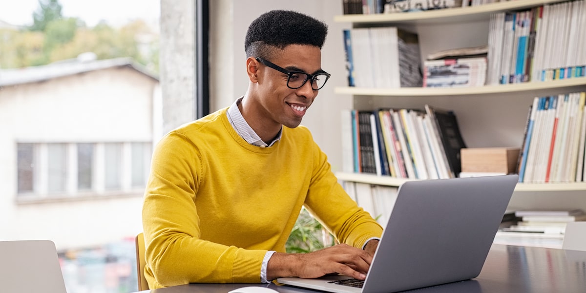 Person writing their resume from home