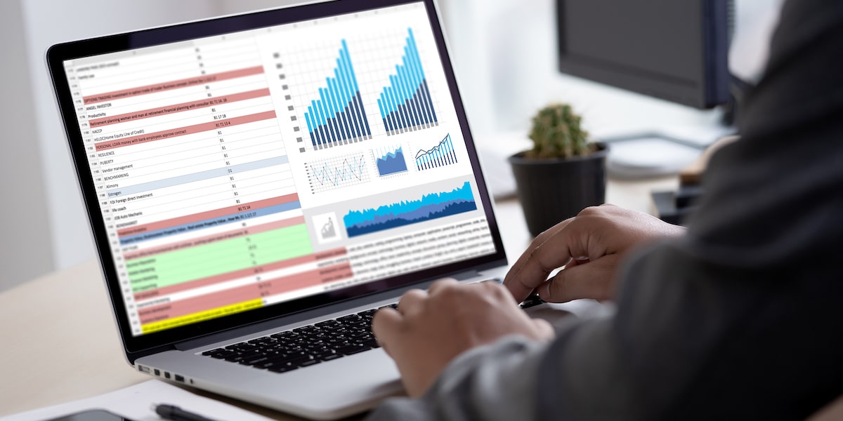 Data analyst making visualizations on a laptop