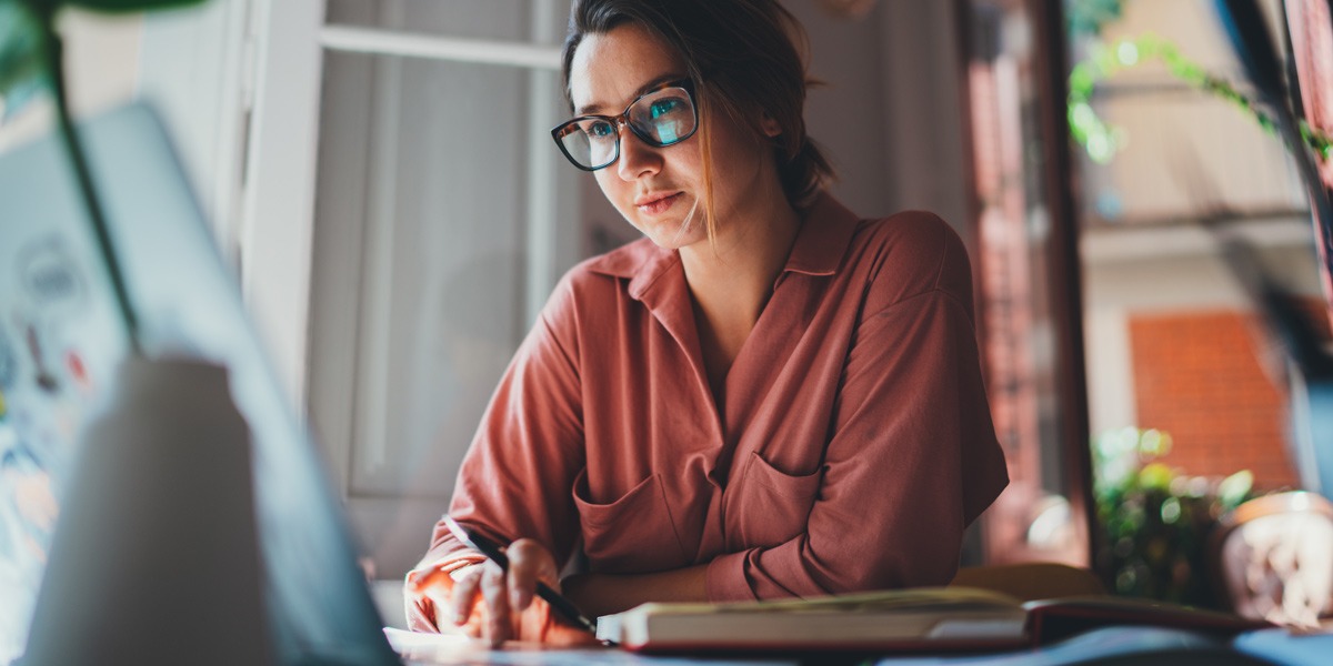 UX designer sitting at a desk drafting microcopy for a product