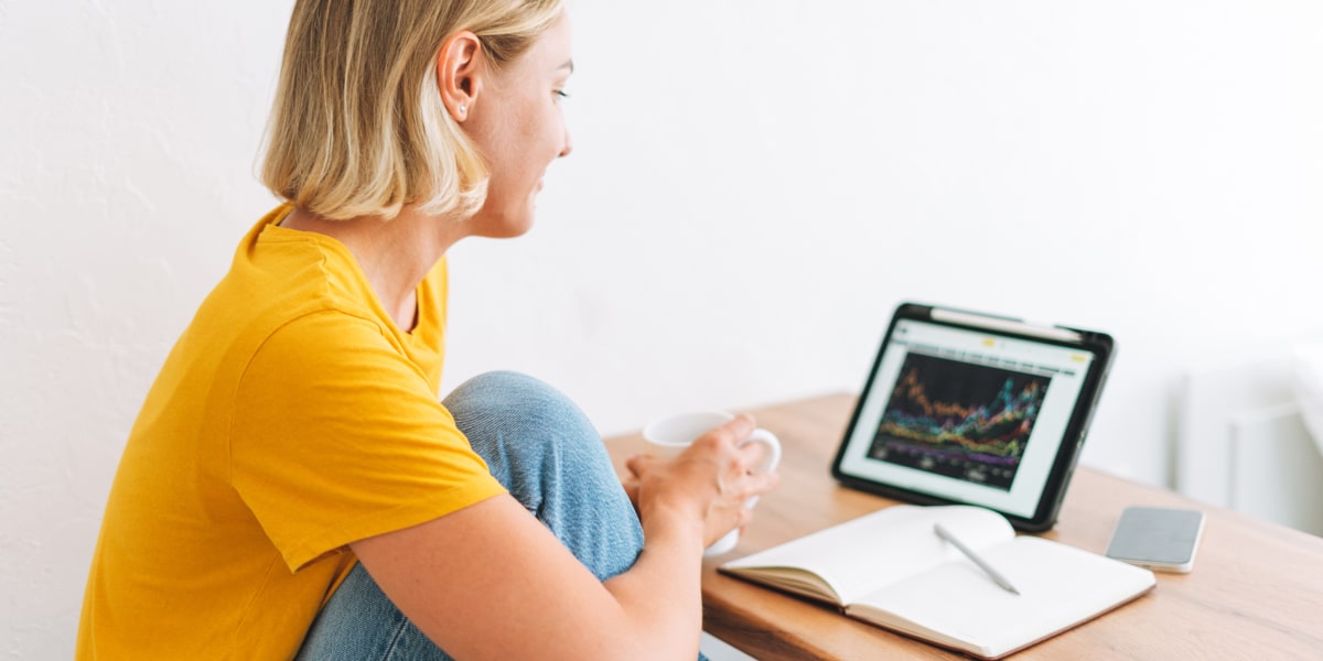 A data analyst in side profile, looking at secondary data on a laptop screen