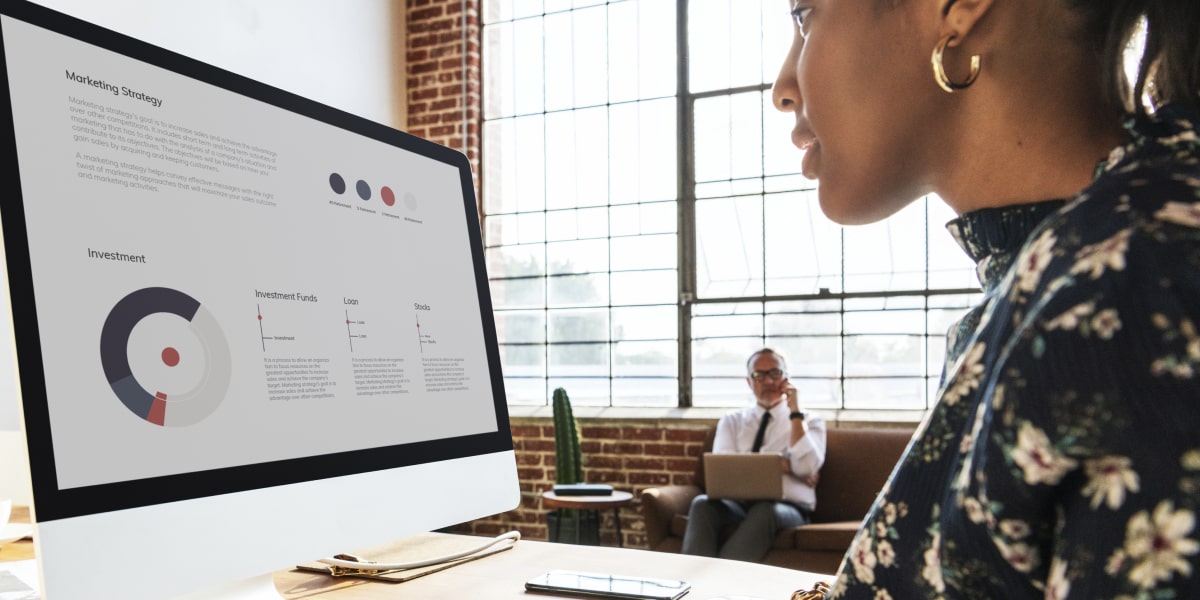 A digital marketing analyst in side profile, looking at a computer screen