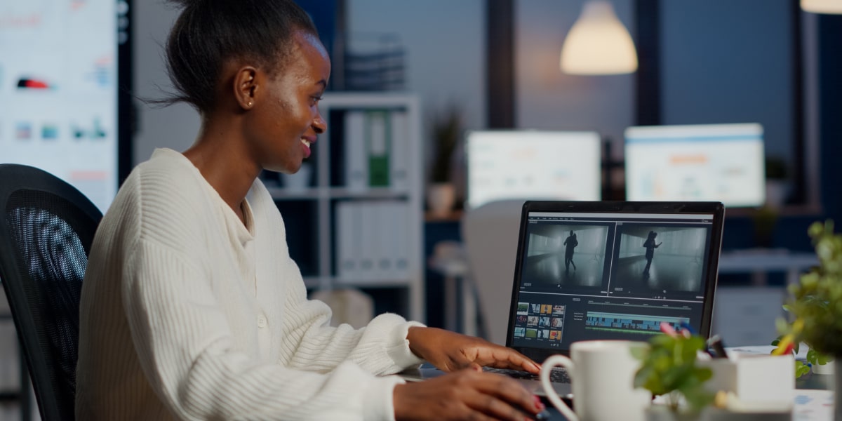 A designer in side profile, working on a laptop using a storyboard template