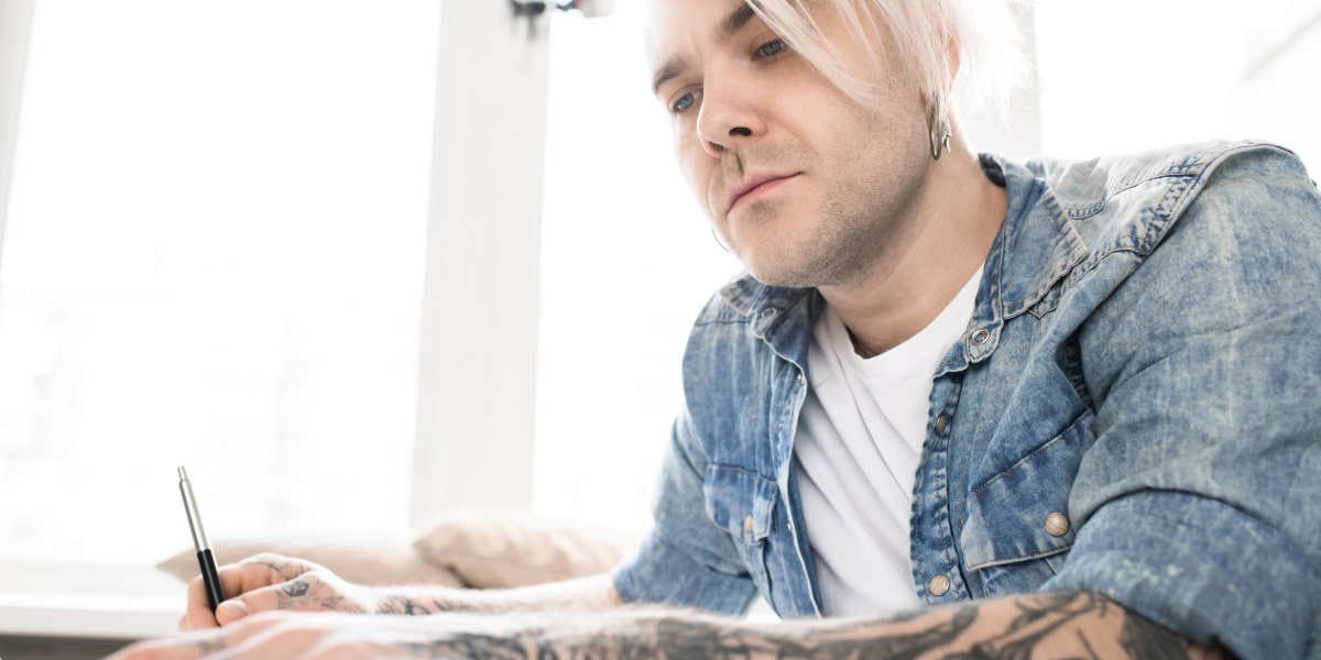 An animation designer sitting at a desk, holding a pen