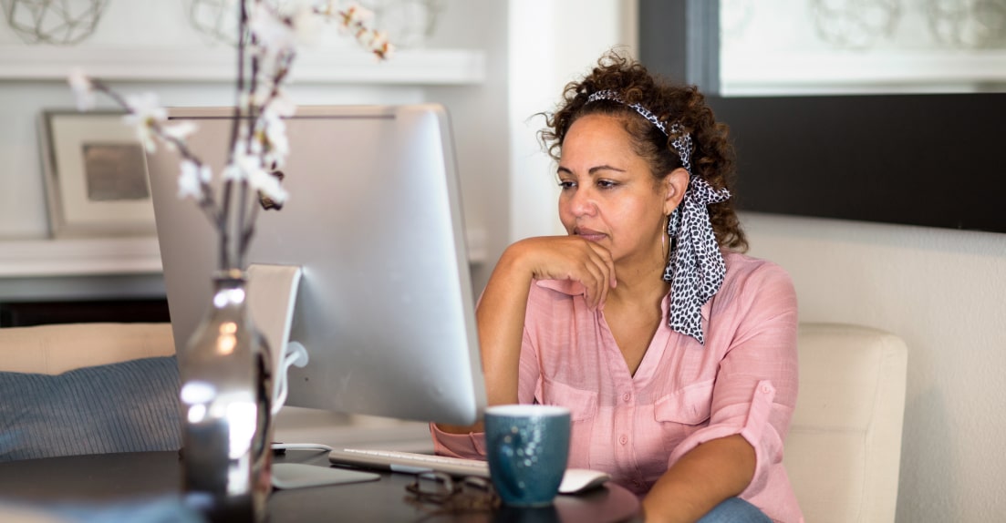 A digital marketing manager working at a desk, analyzing a digital marketing strategy