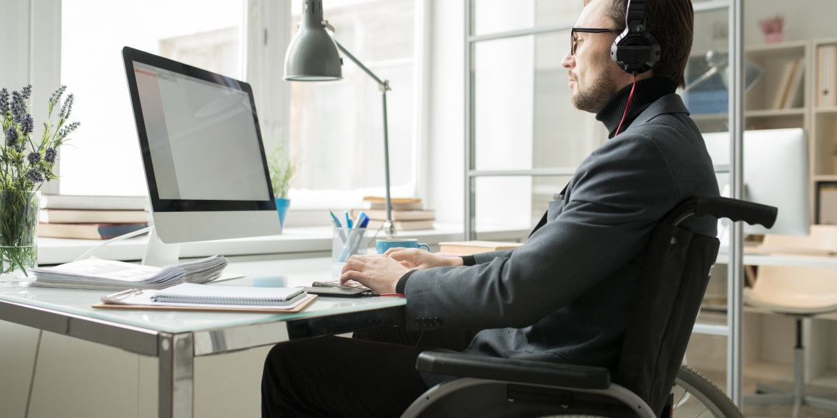 A digital marketing manager working on a computer, setting up email workflows as part of a marketing automation strategy