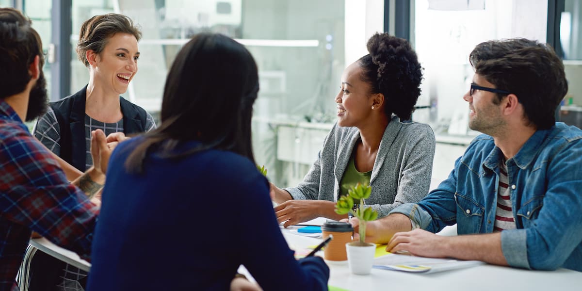 A data ethics consultant discussing topics with three other stakeholders.