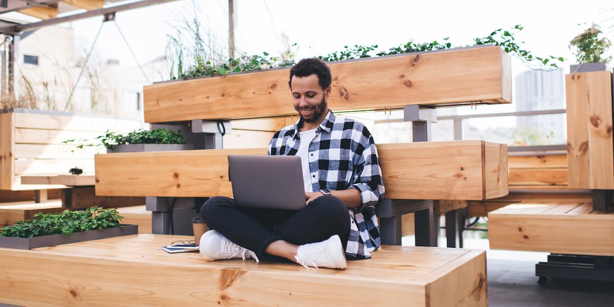 Data scientist working in machine learning jobs sits at his laptop in a modern office.