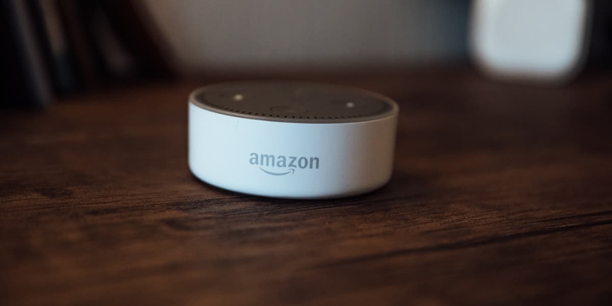 An Amazon Alexa device sitting on a wooden table