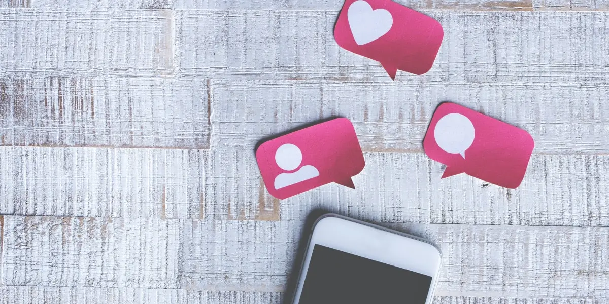 A phone on a tabletop with three paper cutout notificationsRemote UX designers