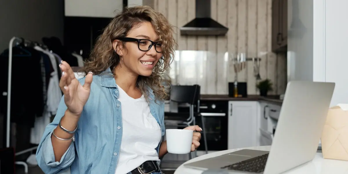 A marketing pro turned UX designer, working from home with her laptop and a cup of coffee