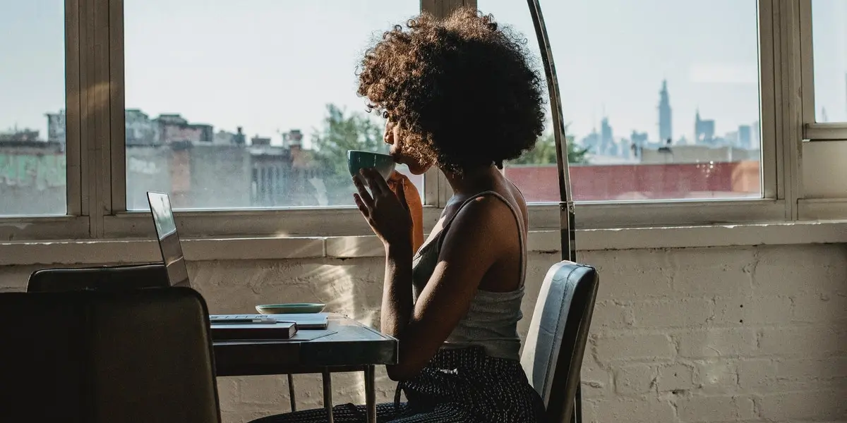 A woman learns web development at home on her laptop