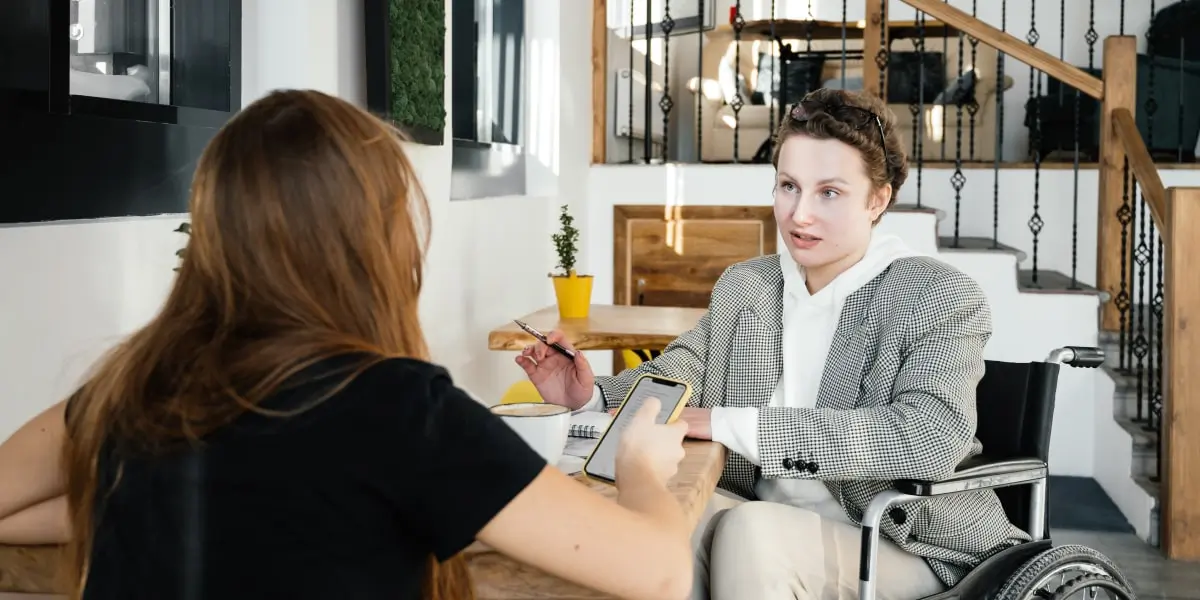 careerpath uxdesign inspiration min Two UX designers sitting in a coffee shop, sharing ideas.