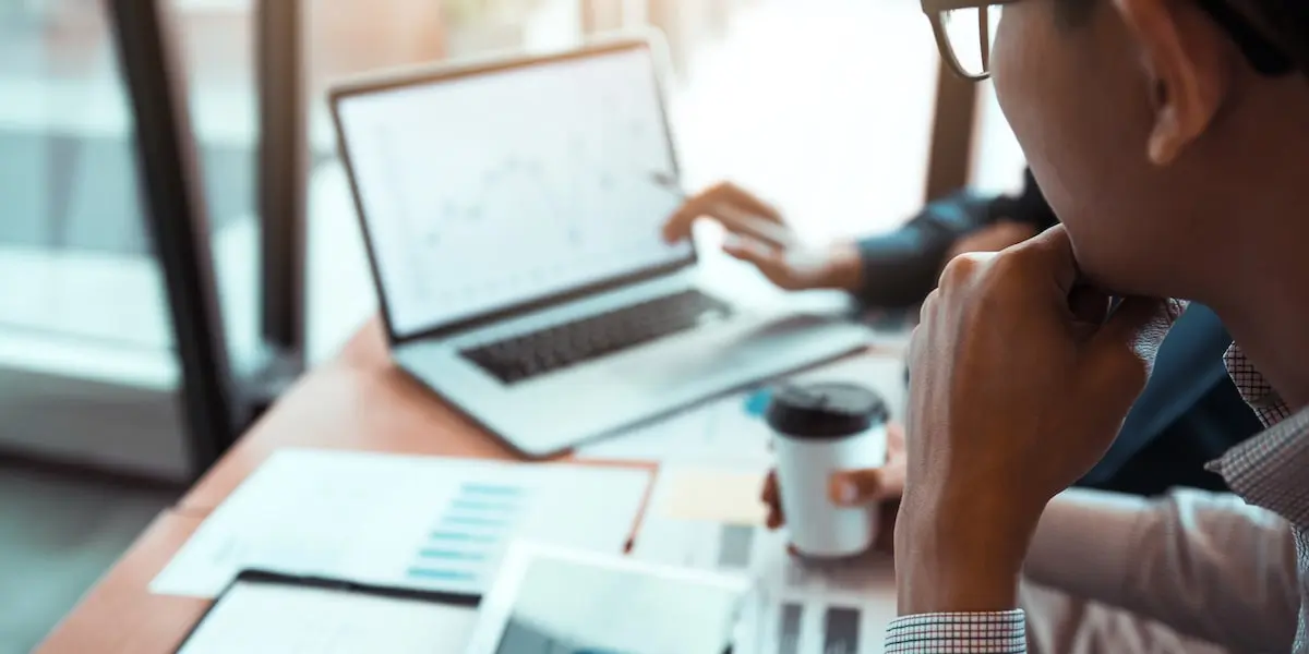 data analysts review data quality Data analyst colleagues review data in an office