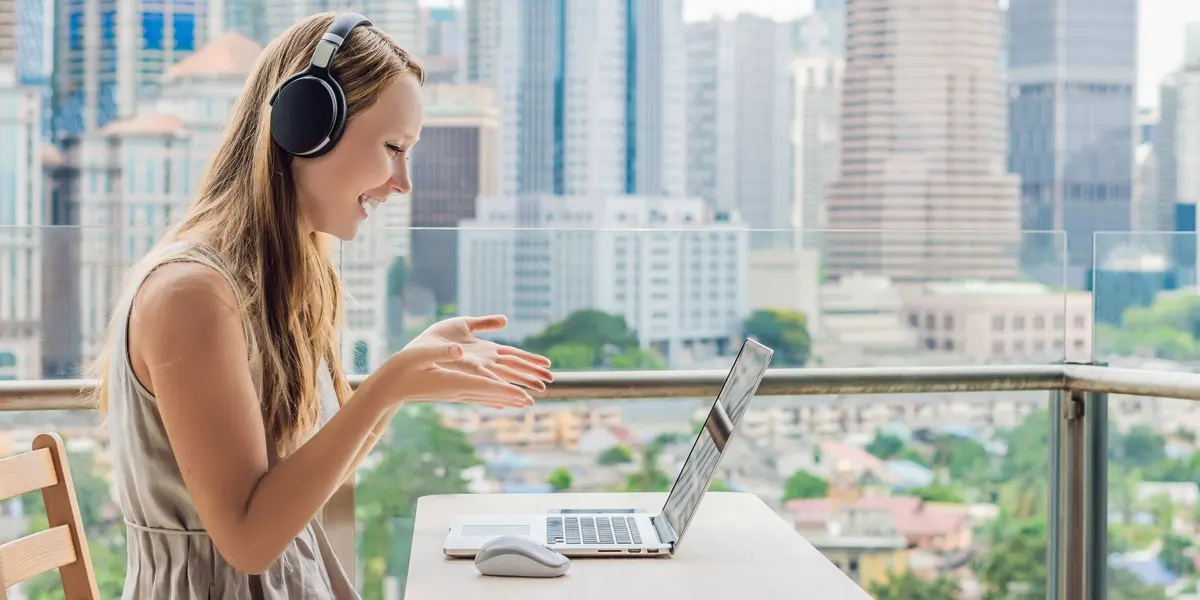 A remote data analyst in side profile, taking a video call against a city backdrop