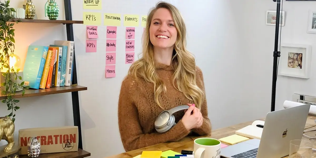 Brittni Bowering, sitting in her home office space, smiling at the camera