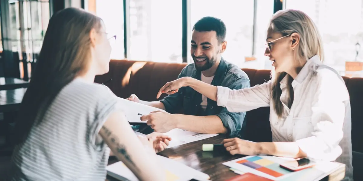 A group of designers sitting around a table discussing a project