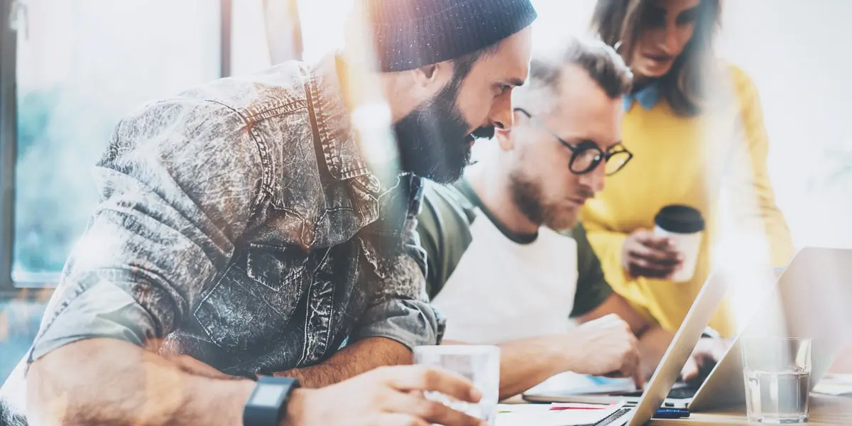 Three designers working in a sunny office