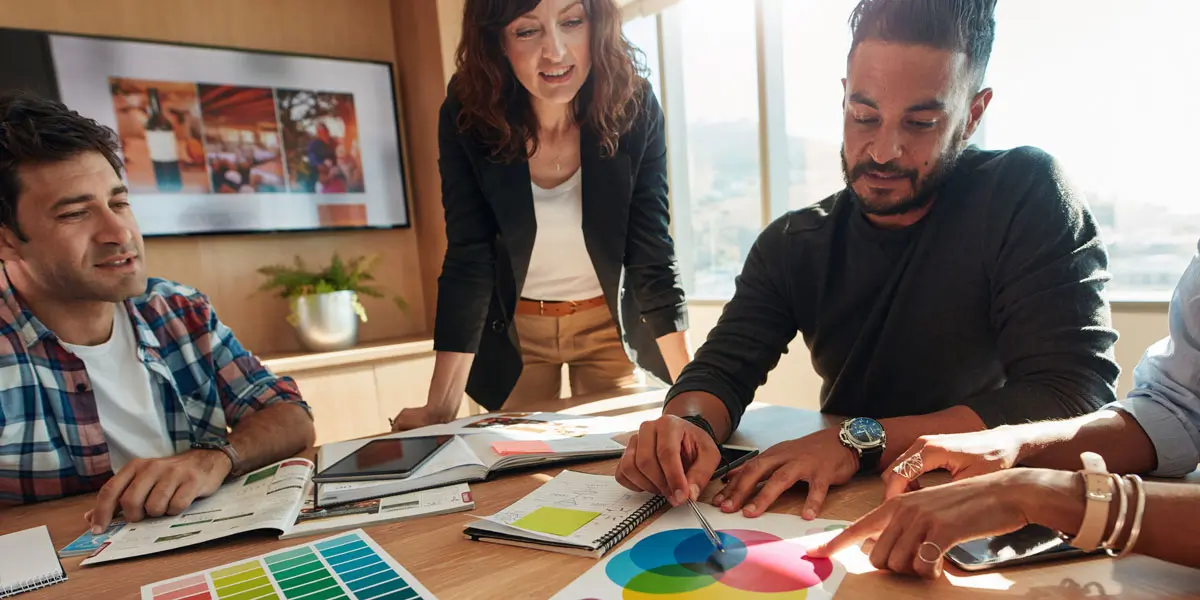 Three UI designers looking at different color palettes