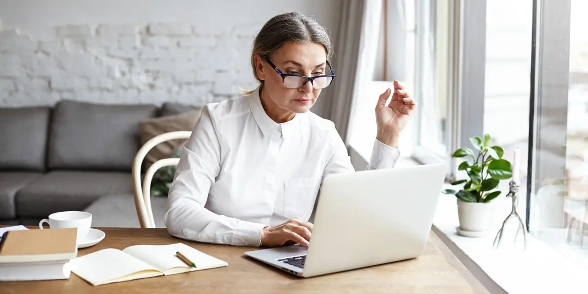 A new UX writer sitting at a desk, working on her portfolio
