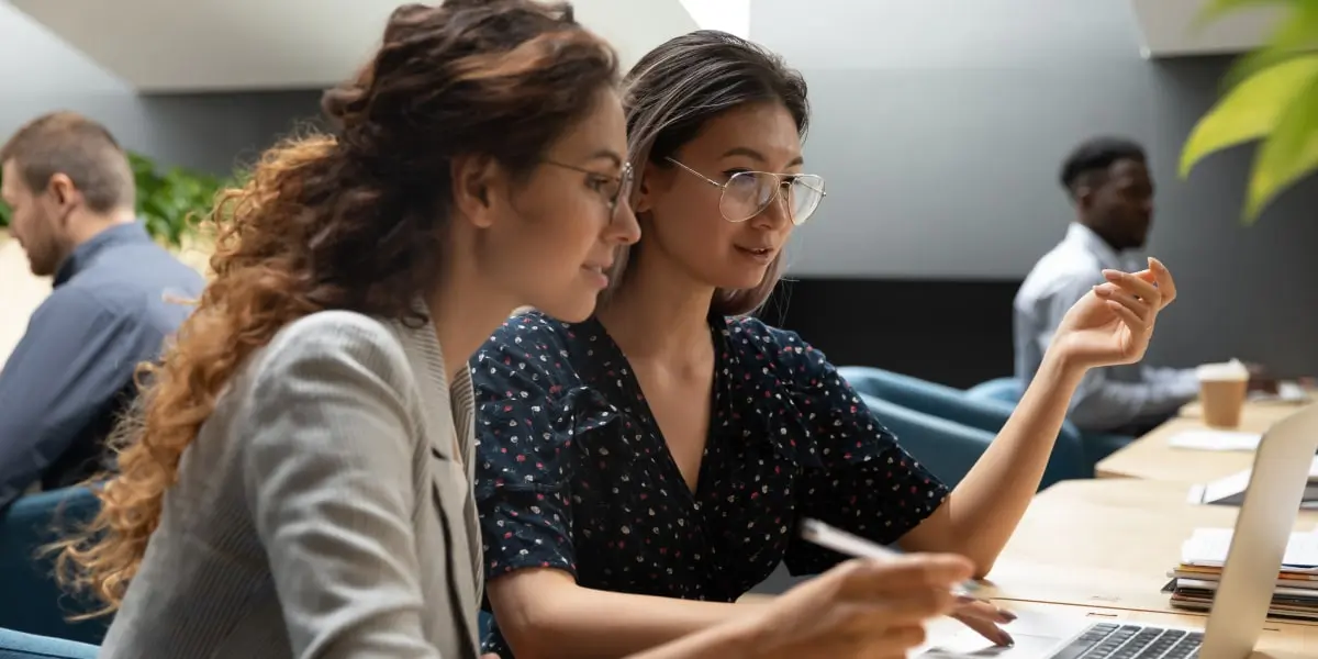 Two aspiring data analysts side by side at a desk
