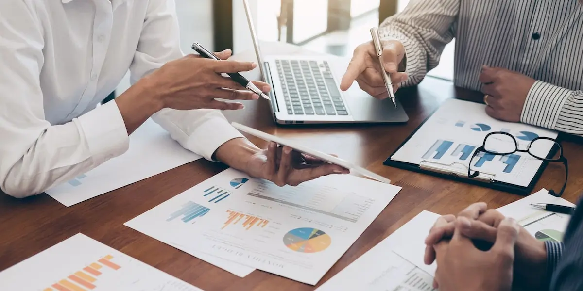 finance analysts collaborating Close up of finance data analysts working together