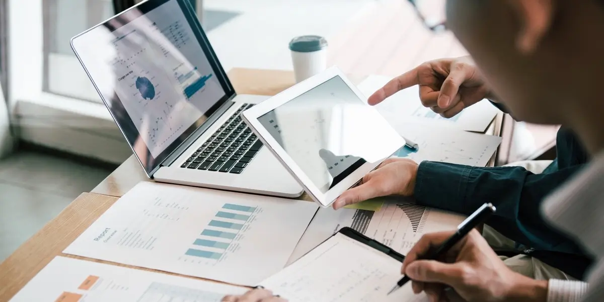 Two designers working at a desk, looking at quantitative research data