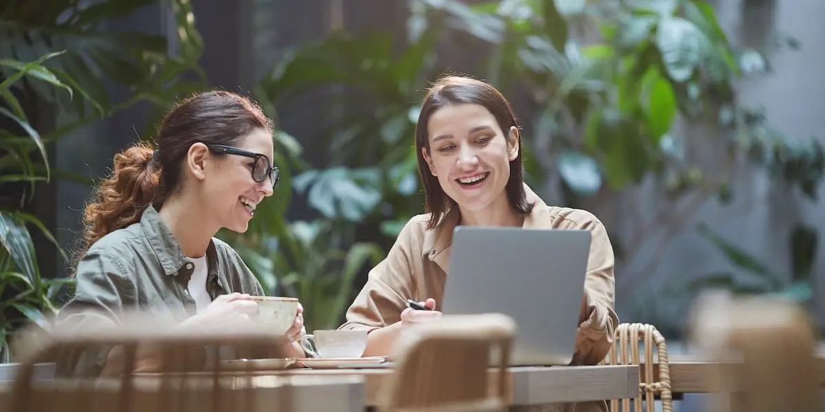 women in tech working at a table outside
