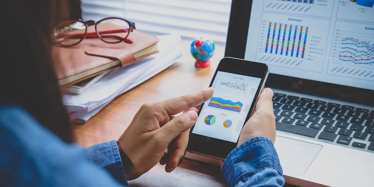 Data analyst views data visualizations on their phone