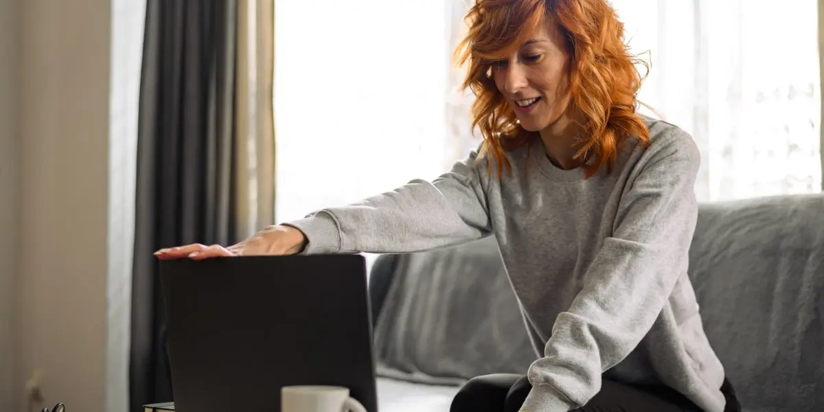 A remote worker sitting in front of a laptop 