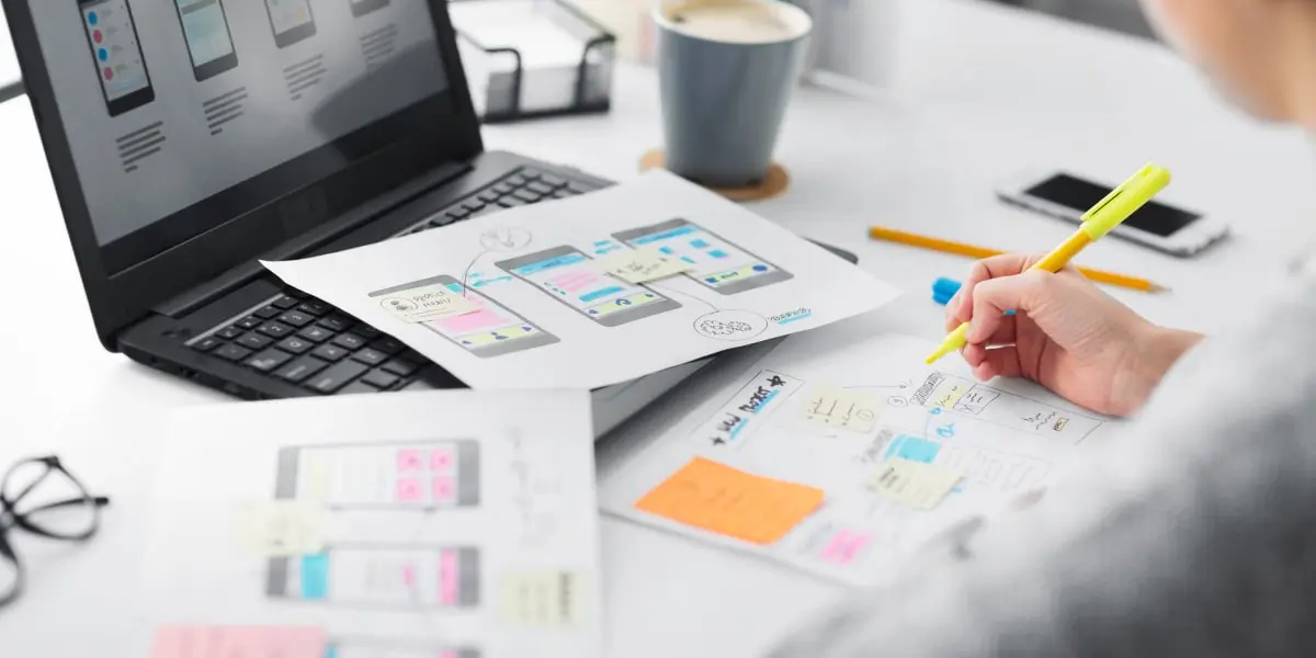 A designer sketching out wireframes