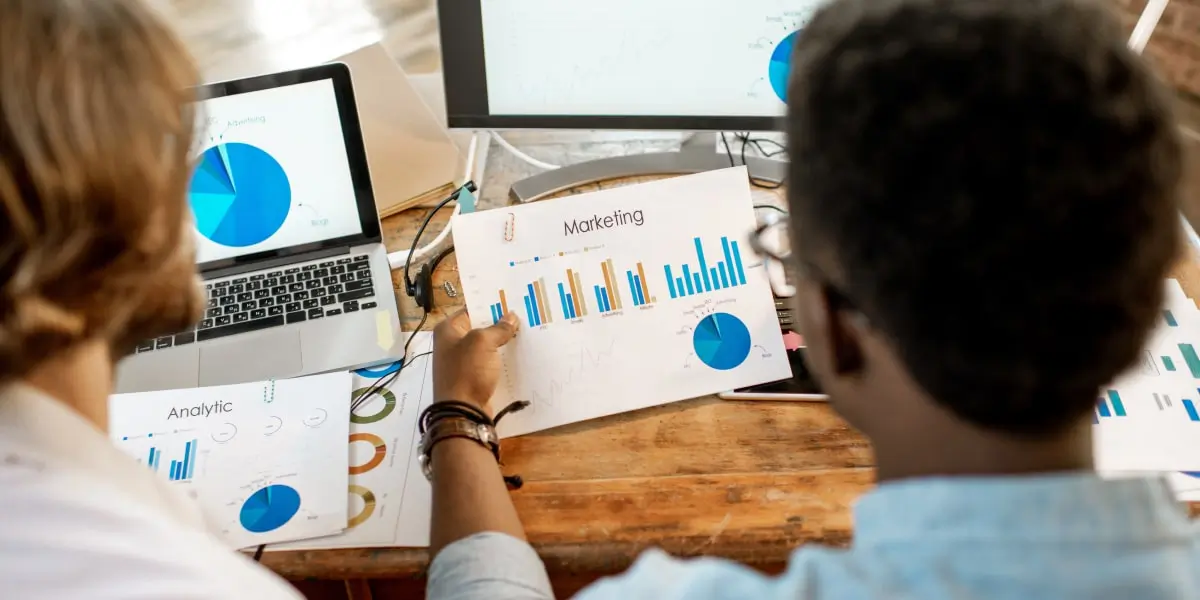 Two digital marketing analysts looking at graphs