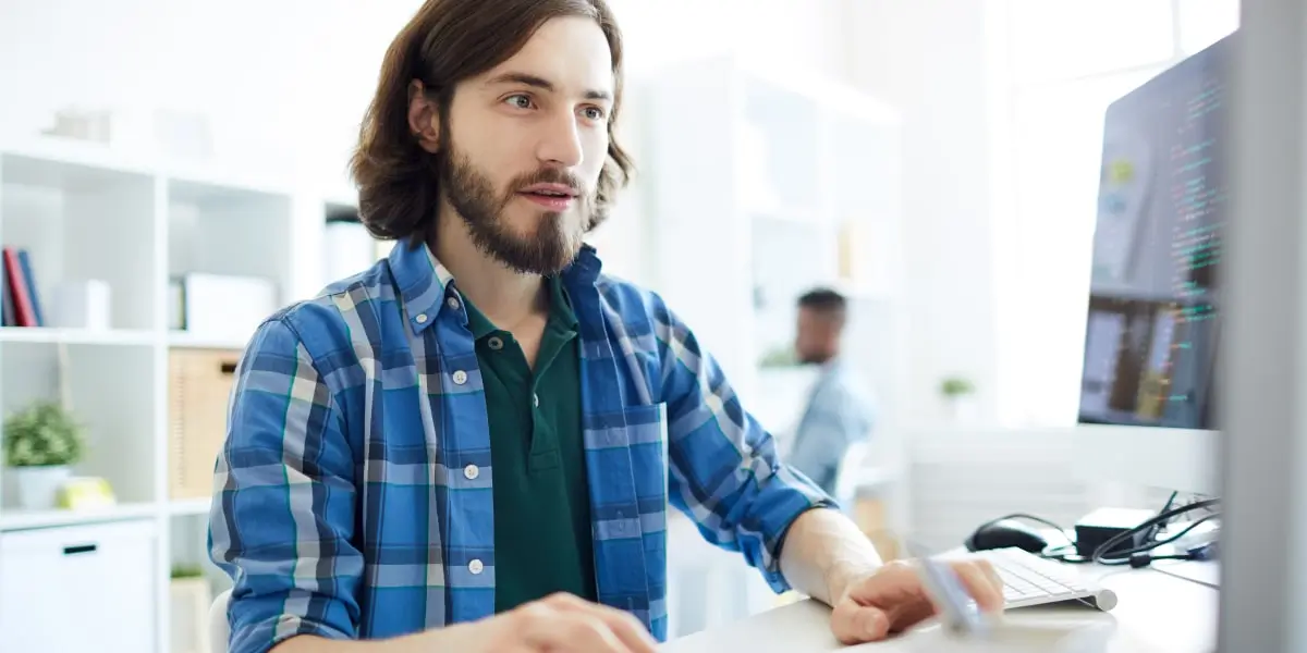 Digital marketing analyst salary A person sitting at a desk, researching the average digital marketing analyst salary on a computer