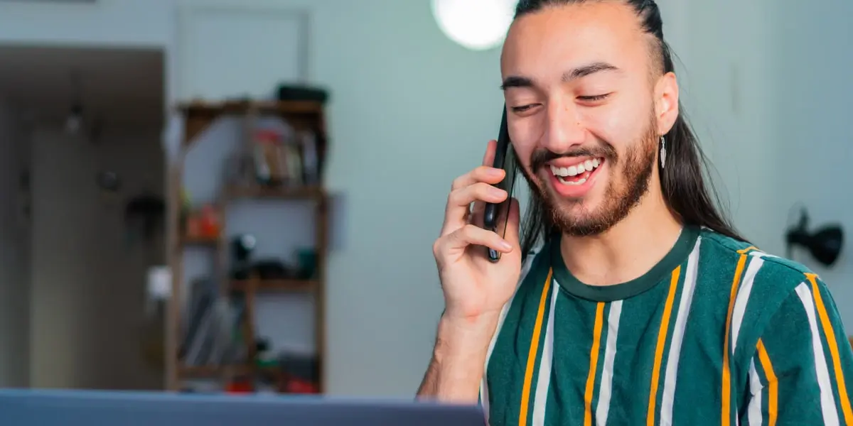 A digital marketing expert speaking into a mobile phone, smiling