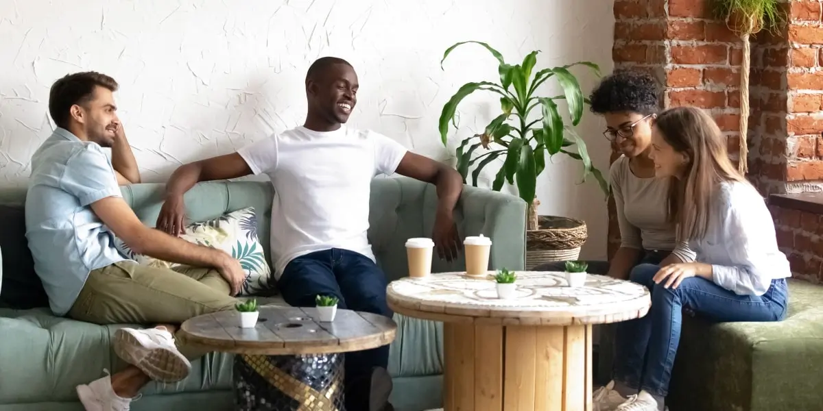 Digital marketing bootcamp A group of digital marketing bootcamp students sitting in a cafe, chatting and laughing