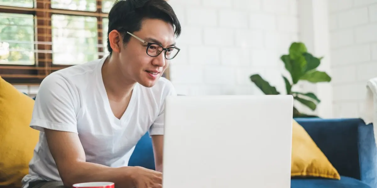 A performance marketing manager in side profile, working on a laptop