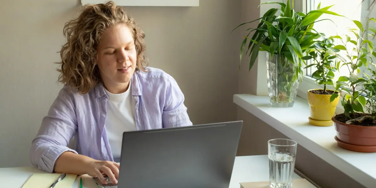 A person working on a laptop, researching the average social media manager salary