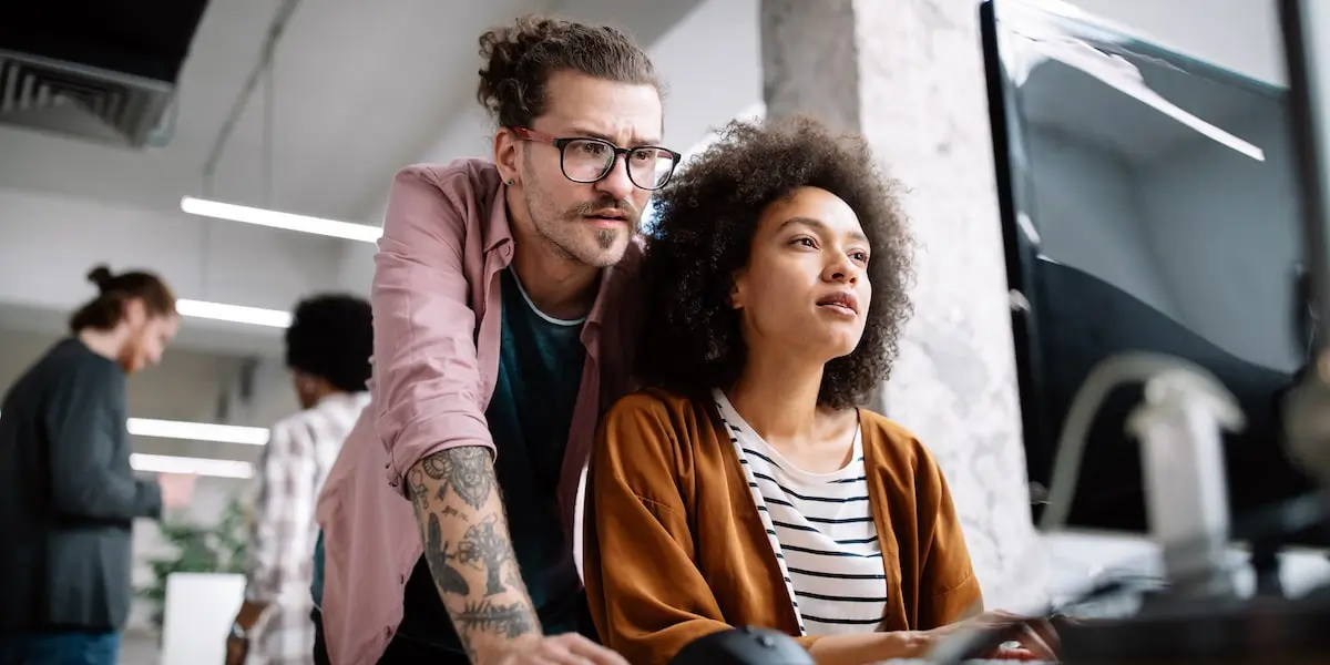 Friend checking their friend's business analyst resume on a desktop computer