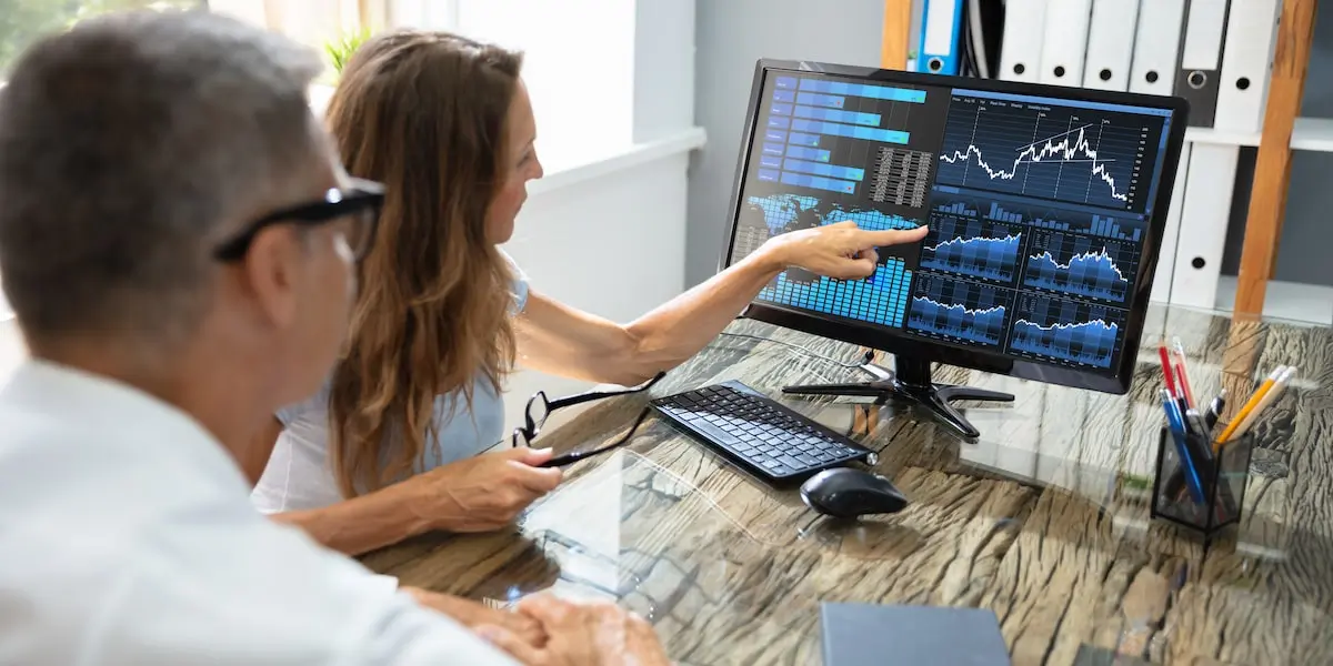 Data analyst colleagues look at visualizations made by predictive analytics tools