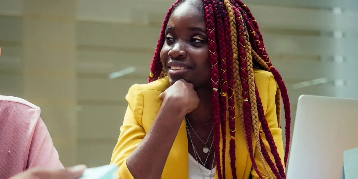 A UX designer sitting at a desk, with a laptop in view