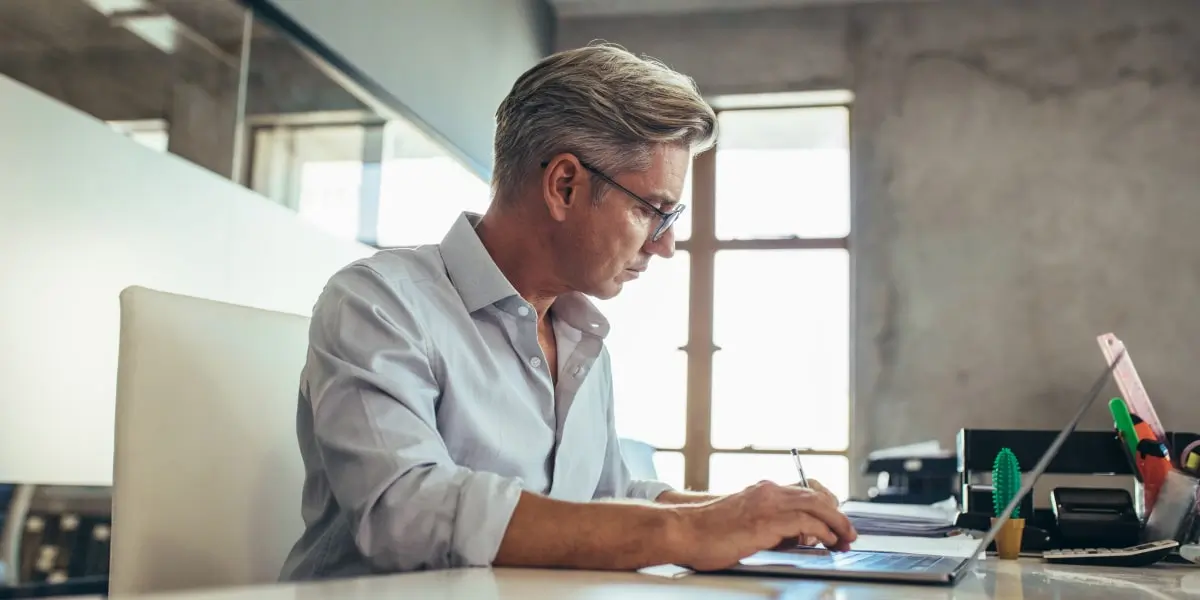 Marketing automation benefits A marketing professional in side profile, typing on a laptop