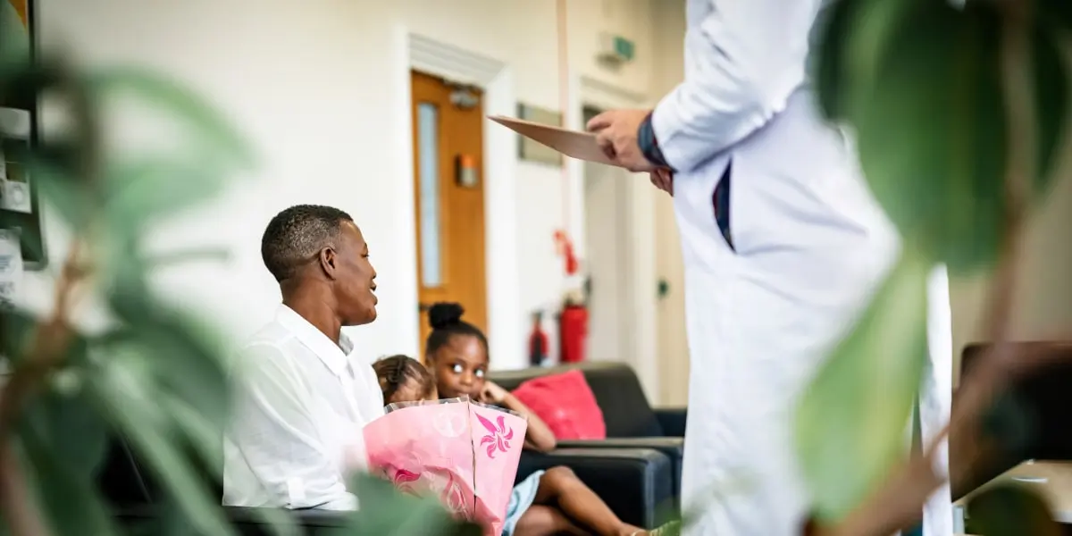 Healthcare is another non technical industry for UX design Image showing a family in a hospital waiting room getting good news from a doctor.