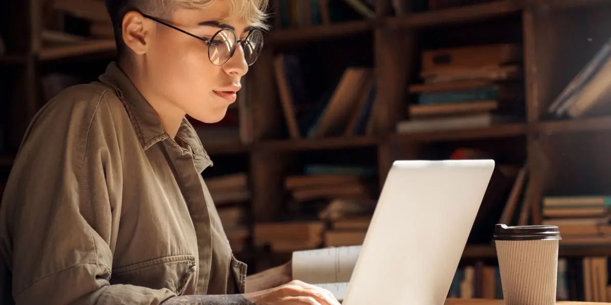 Image of a web developer sitting at her desk in her home office using npm.