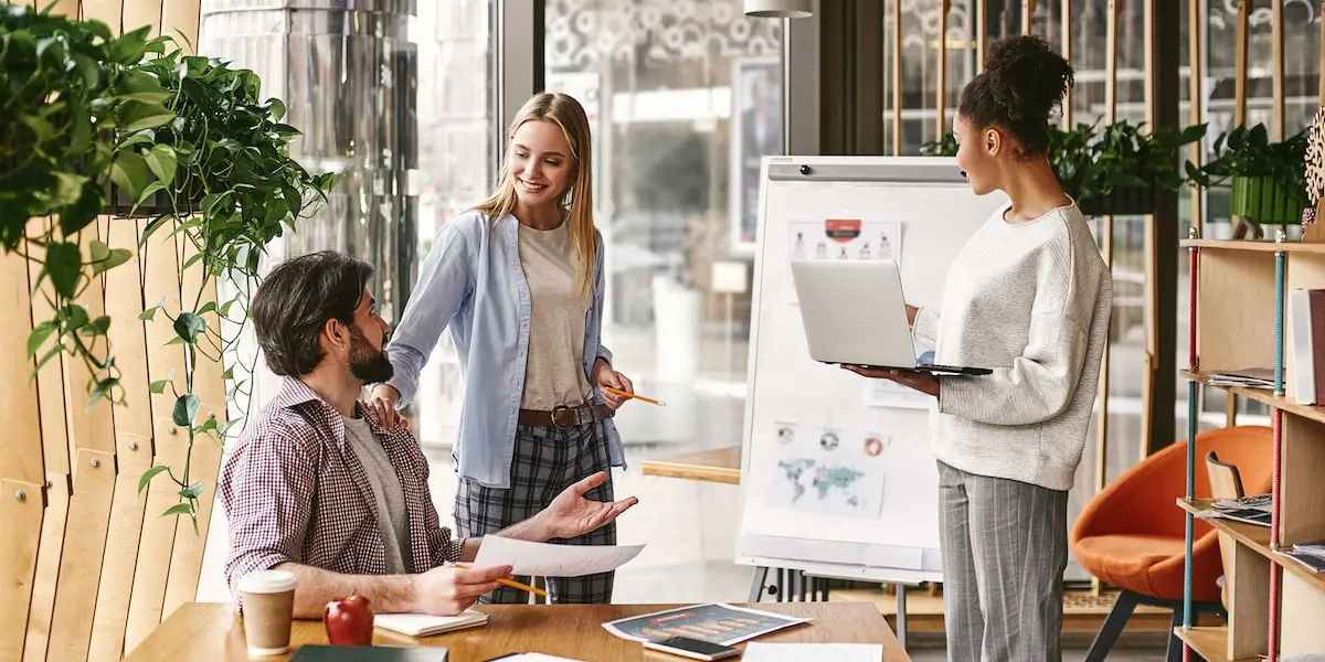A group of colleagues implementing SEO tips during their planning process.