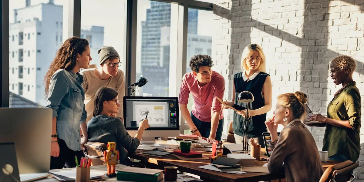 SCAMPER allows designers to be holistic Team of designers SCAMPER brainstorming in a startup office.