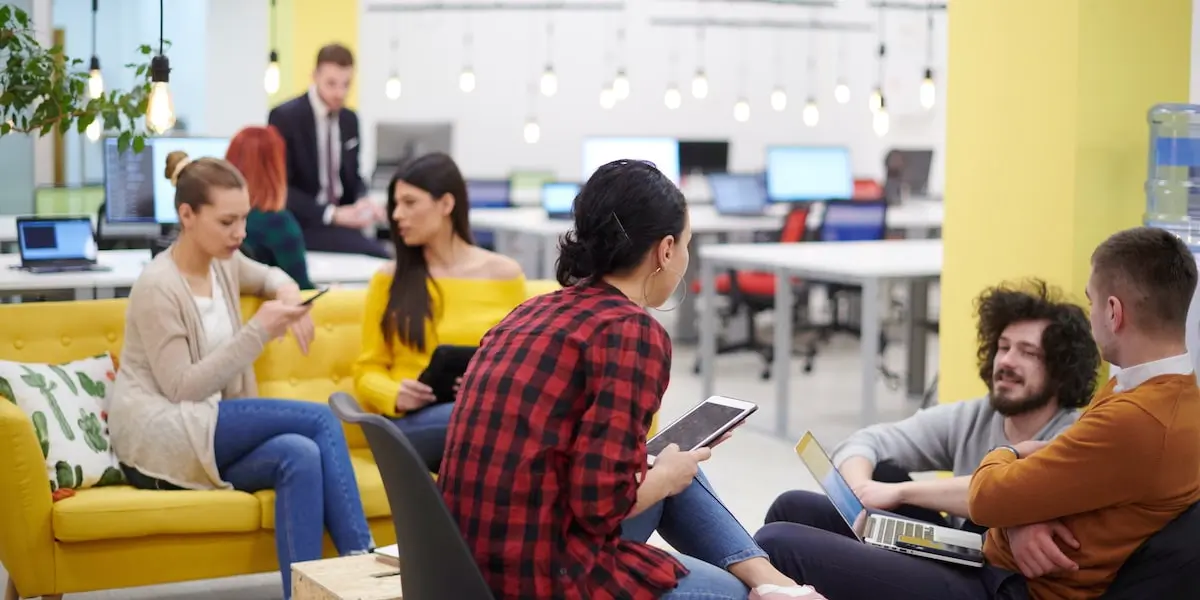 Team of UX designers using the SCAMPER technique to brainstorm in an office.
