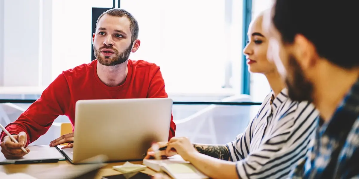 Participants in a user interview are asked a question by the researcher.