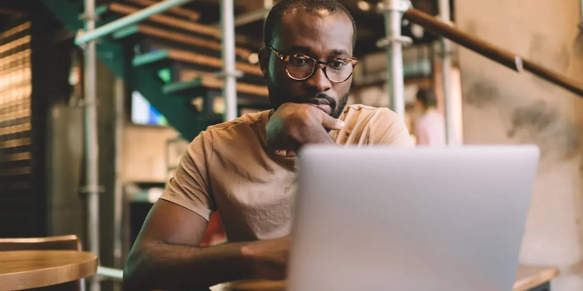 Man sitting in front of his laptop, preparing to answer machine learning interview questions