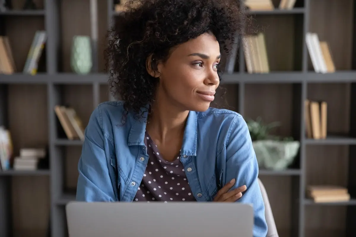 Software engineer sits at home working on her laptop.