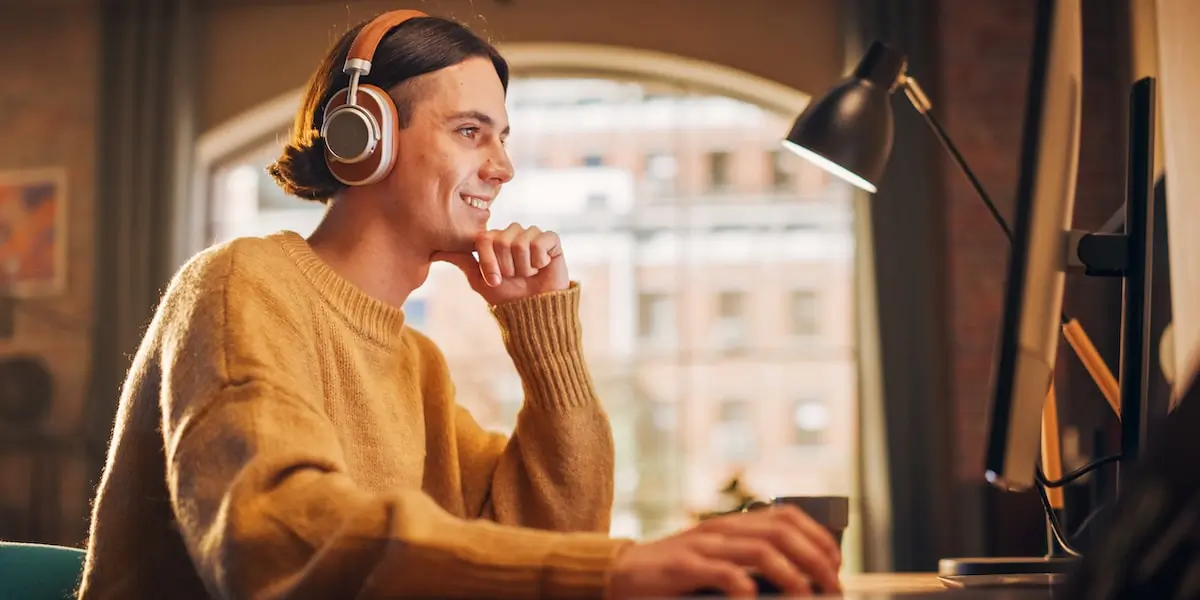 A cloud developer happily working in their home office using AWS S3.